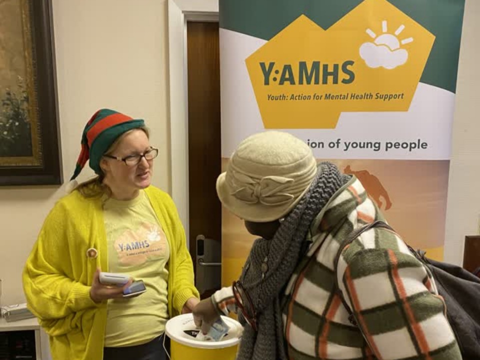 Rachel Colbran accepting donations to Y:AMHS at the Charity Concert on December 17, 2022.